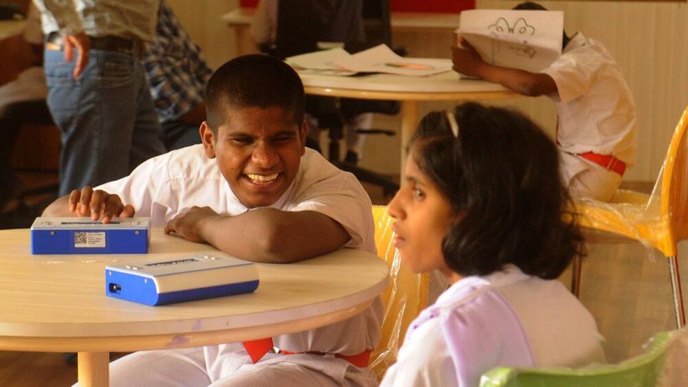 Priyajit utilising a Tech Assistive Device (left)