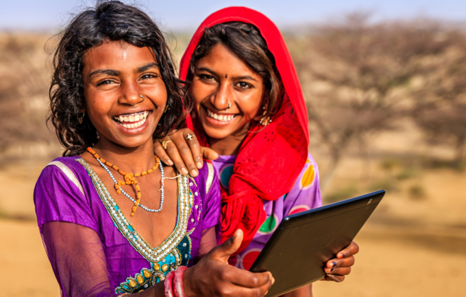 Two Adolescent Girls Holding a Tablet