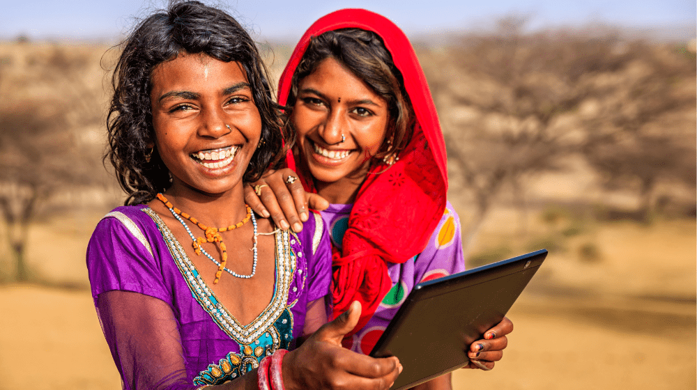 Two Adolescent Girls Holding a Tablet